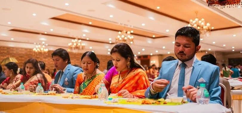 Guests sharing a traditional meal at a celebration