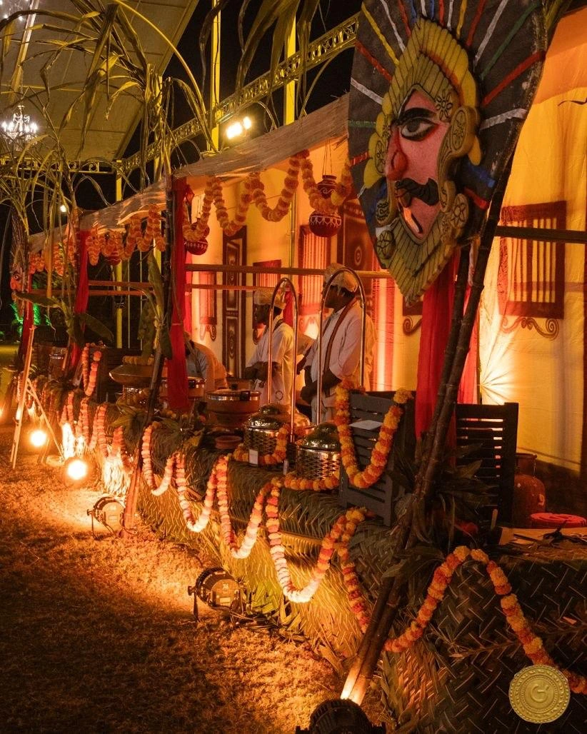 Traditional catering counter decorated with marigolds, banana leaves and a colourful ceremonial mask